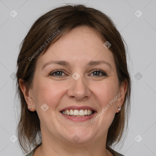 Joyful white adult female with medium  brown hair and grey eyes