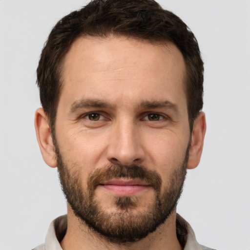 Joyful white young-adult male with short  brown hair and brown eyes