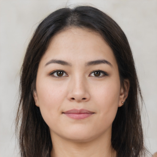 Joyful asian young-adult female with long  brown hair and brown eyes