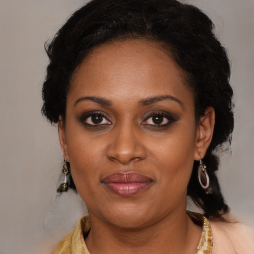 Joyful latino adult female with medium  black hair and brown eyes