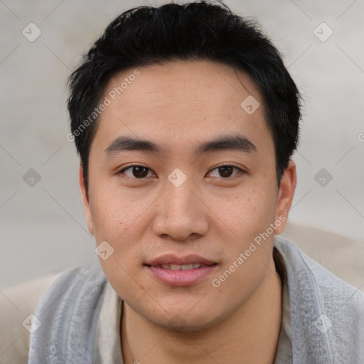 Joyful asian young-adult male with short  black hair and brown eyes