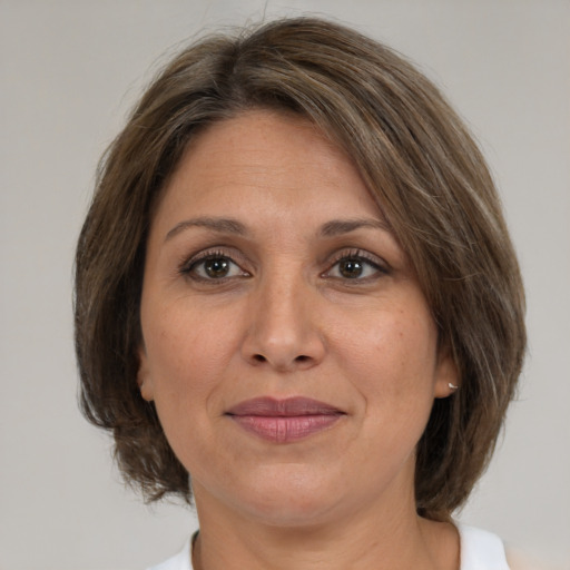 Joyful white adult female with medium  brown hair and brown eyes