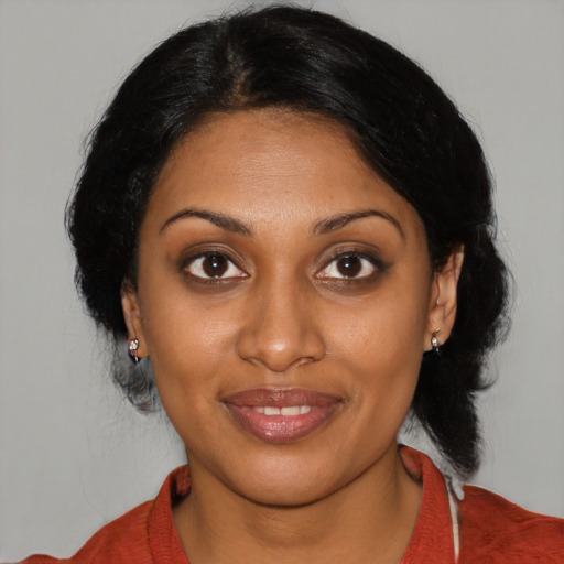 Joyful black young-adult female with medium  black hair and brown eyes