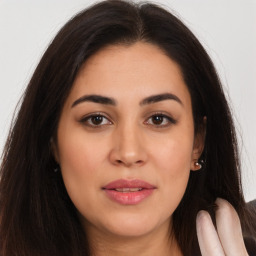 Joyful white young-adult female with long  brown hair and brown eyes