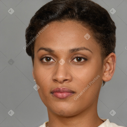 Joyful black young-adult female with short  brown hair and brown eyes