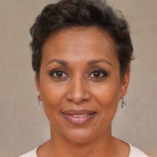 Joyful black adult female with short  brown hair and brown eyes