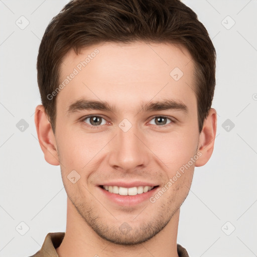 Joyful white young-adult male with short  brown hair and grey eyes