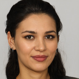 Joyful latino young-adult female with long  brown hair and brown eyes