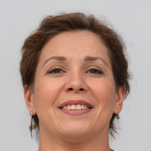 Joyful white adult female with short  brown hair and brown eyes