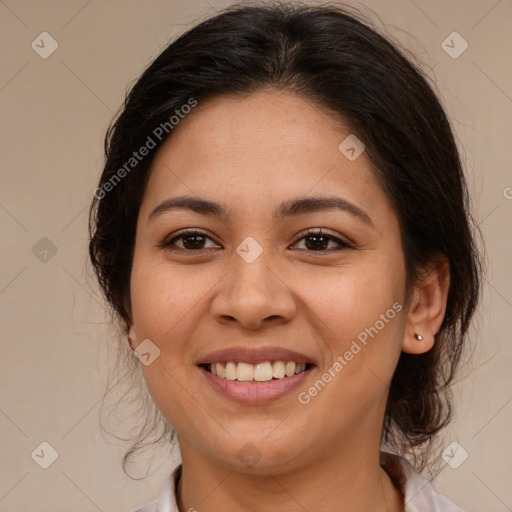 Joyful latino young-adult female with medium  brown hair and brown eyes