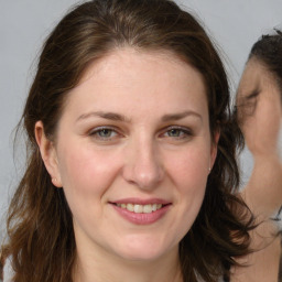 Joyful white adult female with medium  brown hair and brown eyes