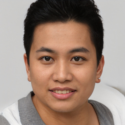 Joyful asian young-adult male with short  brown hair and brown eyes