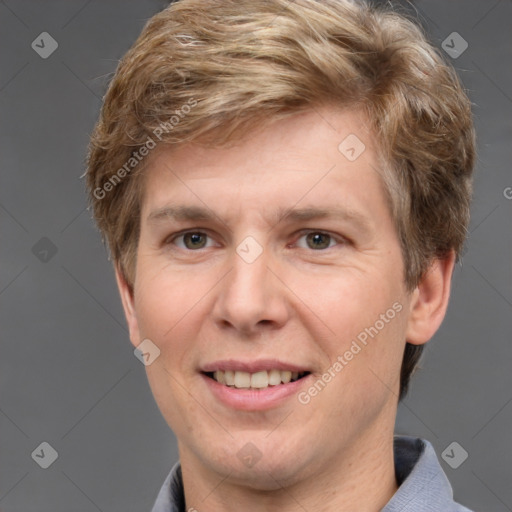 Joyful white adult male with short  brown hair and grey eyes