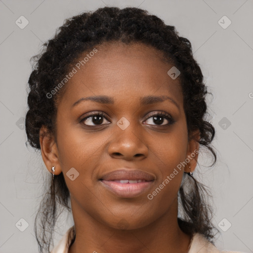 Joyful black young-adult female with long  brown hair and brown eyes