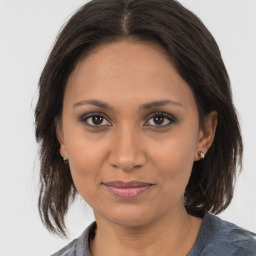 Joyful latino young-adult female with medium  brown hair and brown eyes