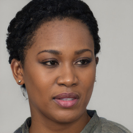 Joyful black young-adult female with short  black hair and brown eyes