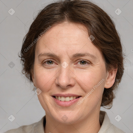 Joyful white adult female with medium  brown hair and grey eyes