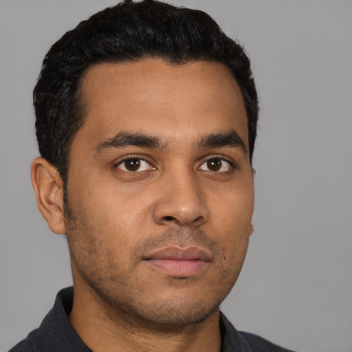 Neutral latino young-adult male with short  brown hair and brown eyes