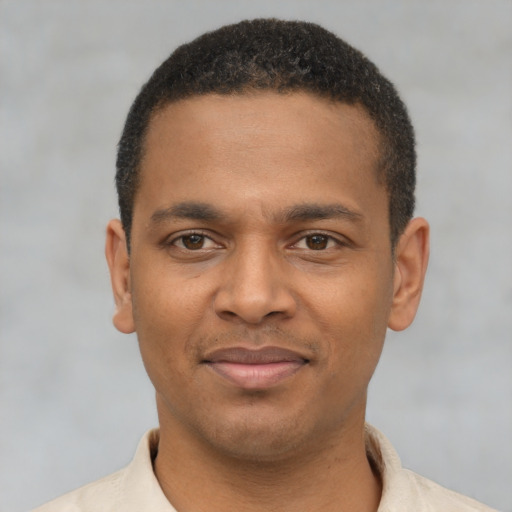 Joyful latino young-adult male with short  brown hair and brown eyes