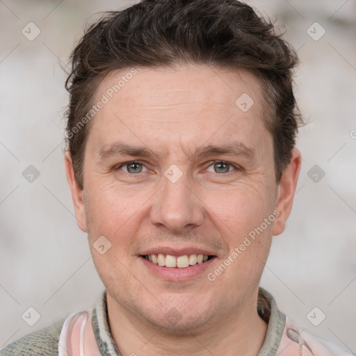 Joyful white adult male with short  brown hair and grey eyes