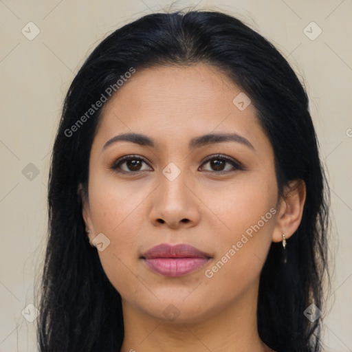 Joyful latino young-adult female with long  brown hair and brown eyes