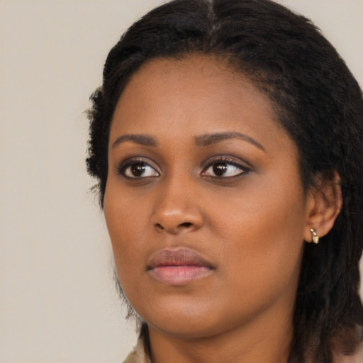 Neutral black young-adult female with long  brown hair and brown eyes