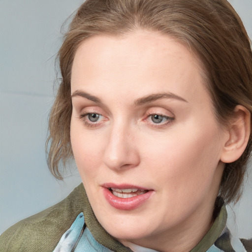 Joyful white young-adult female with medium  brown hair and blue eyes