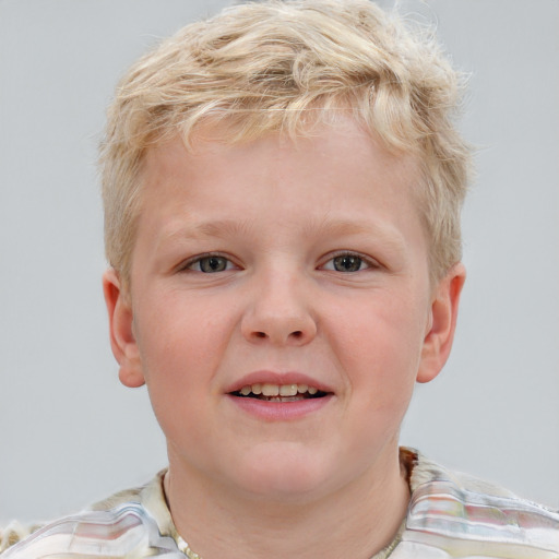 Joyful white child male with short  blond hair and blue eyes