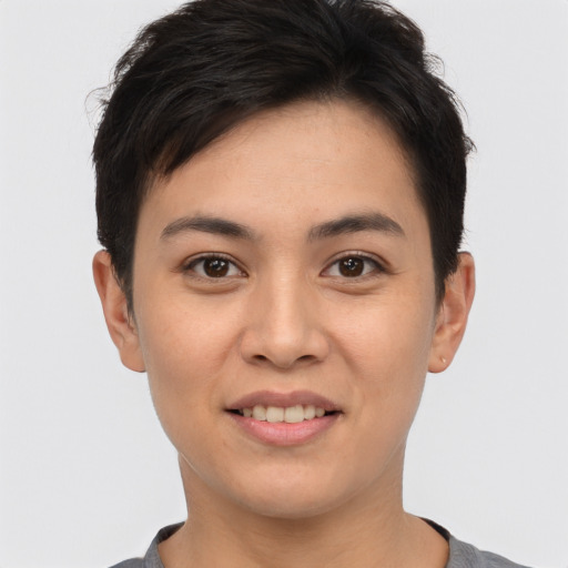 Joyful asian young-adult female with short  brown hair and brown eyes