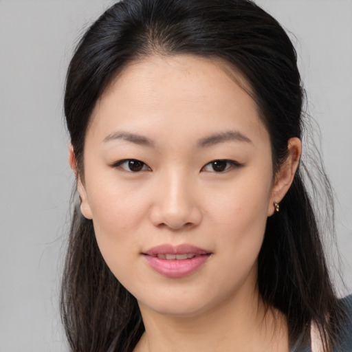 Joyful asian young-adult female with long  brown hair and brown eyes