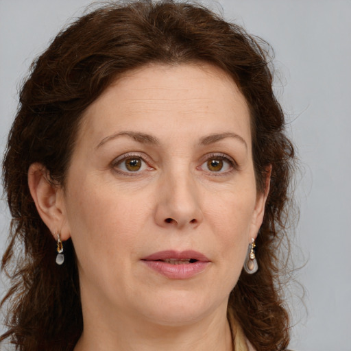 Joyful white adult female with long  brown hair and green eyes