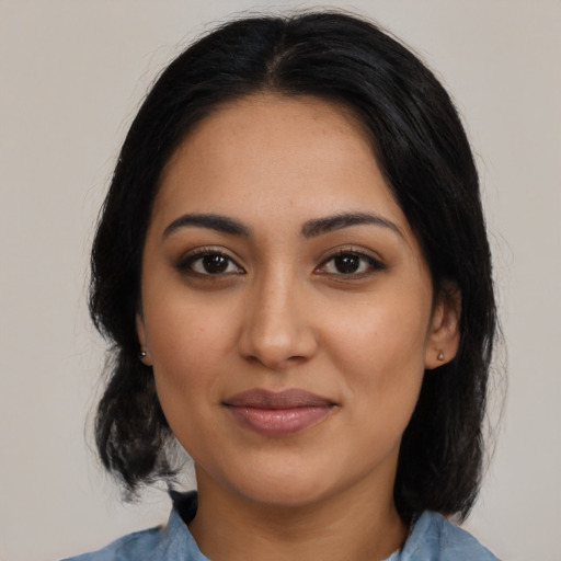 Joyful latino young-adult female with medium  black hair and brown eyes