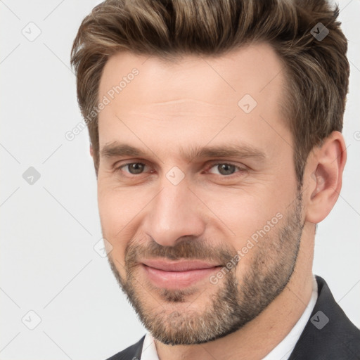 Joyful white adult male with short  brown hair and brown eyes