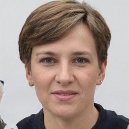 Joyful white adult female with short  brown hair and grey eyes