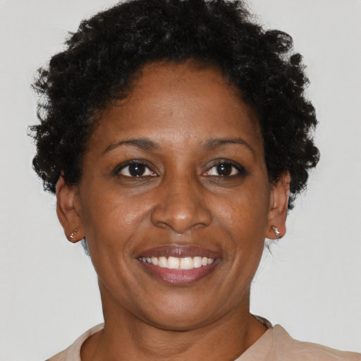 Joyful black adult female with short  brown hair and brown eyes