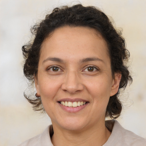 Joyful white adult female with medium  brown hair and brown eyes