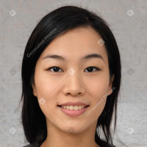 Joyful asian young-adult female with medium  black hair and brown eyes