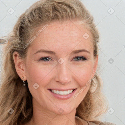 Joyful white adult female with long  brown hair and blue eyes