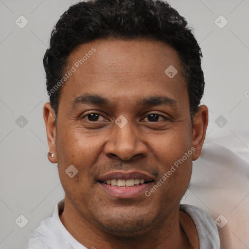 Joyful latino adult male with short  black hair and brown eyes