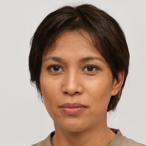 Joyful white adult female with medium  brown hair and brown eyes