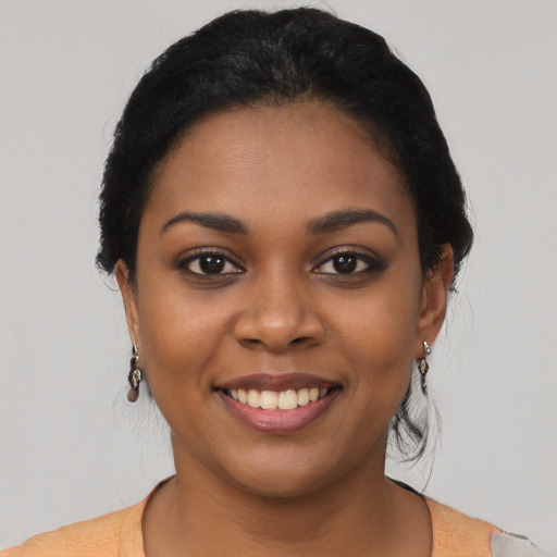 Joyful latino young-adult female with short  black hair and brown eyes