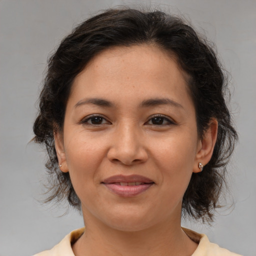 Joyful white adult female with medium  brown hair and brown eyes