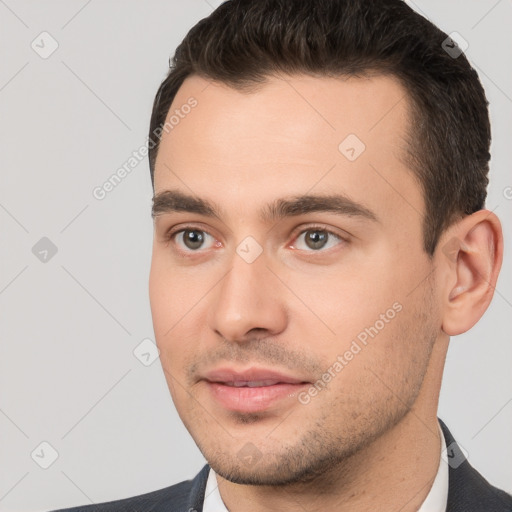 Joyful white young-adult male with short  brown hair and brown eyes