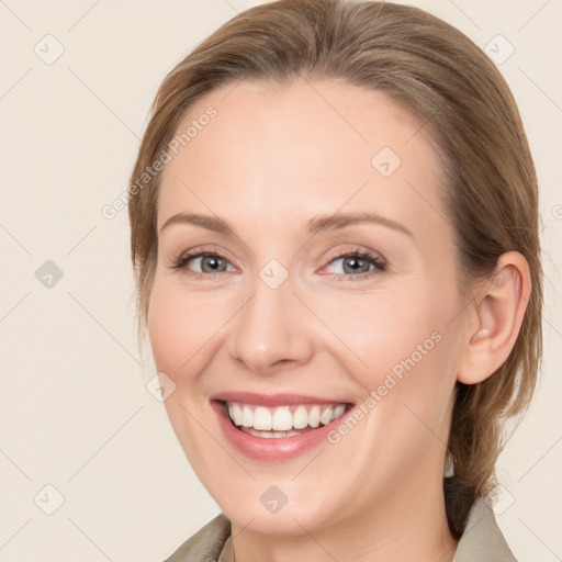 Joyful white young-adult female with medium  brown hair and grey eyes