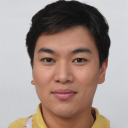 Joyful asian young-adult male with short  brown hair and brown eyes