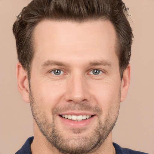 Joyful white young-adult male with short  brown hair and brown eyes