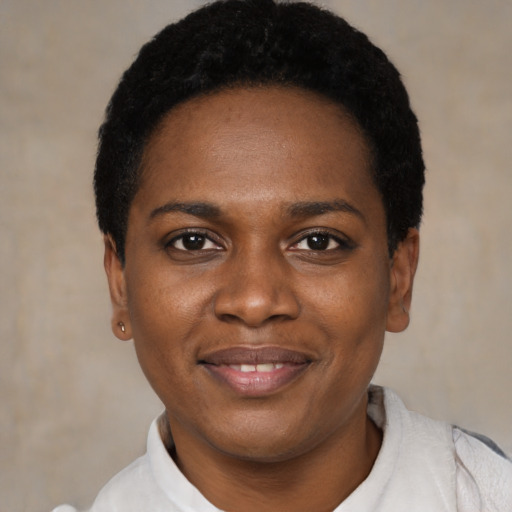 Joyful black young-adult female with short  black hair and brown eyes
