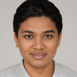 Joyful latino young-adult male with short  black hair and brown eyes