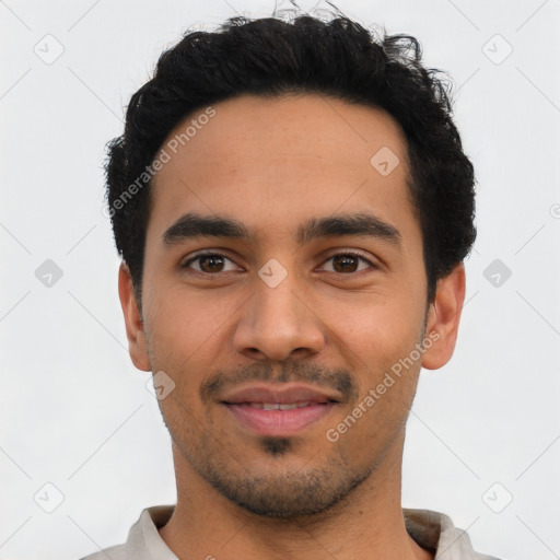 Joyful latino young-adult male with short  black hair and brown eyes