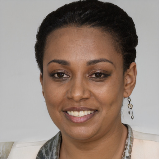 Joyful black young-adult female with short  black hair and brown eyes